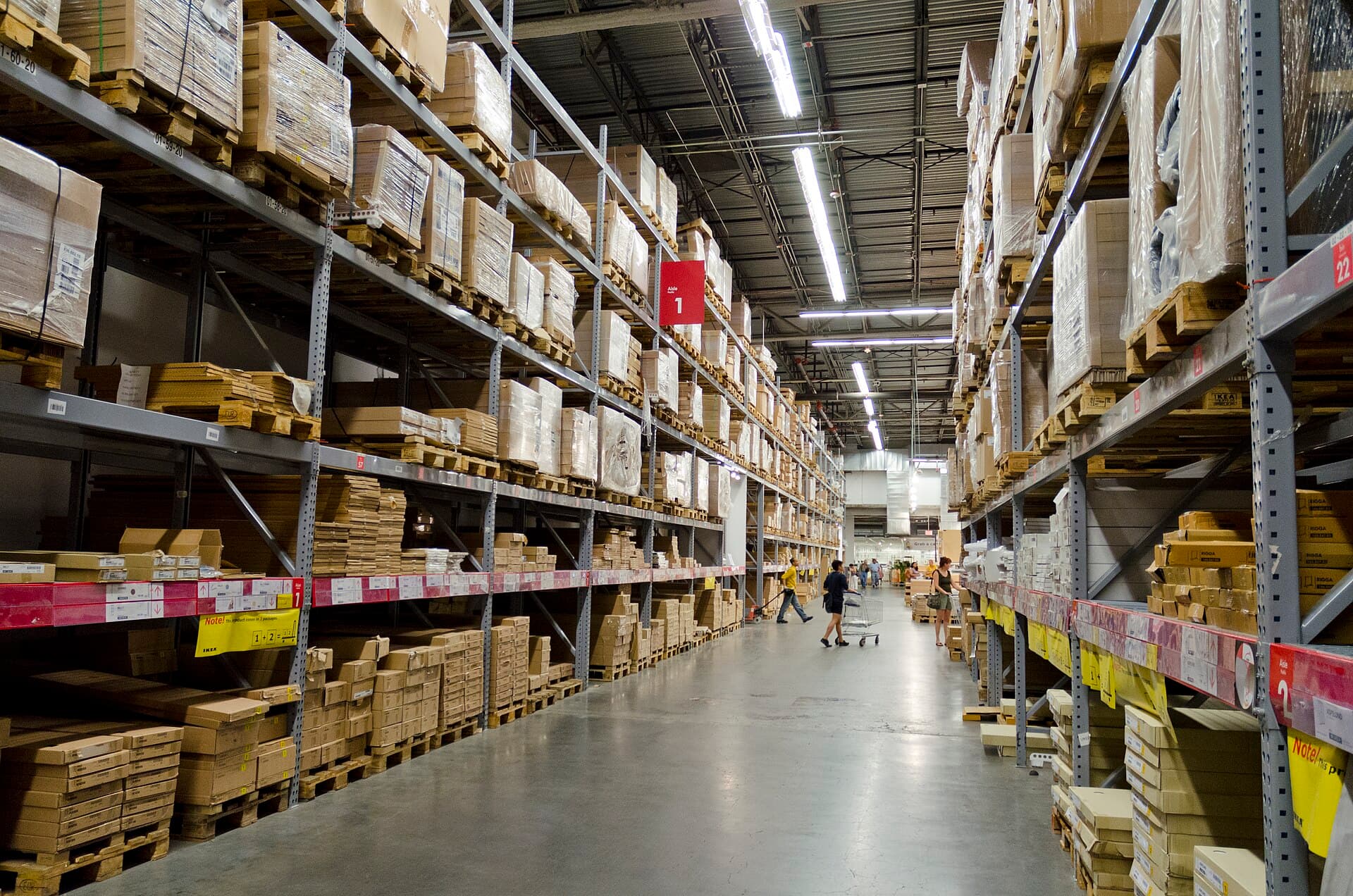 Tall warehouse aisles with boxed inventory on racks